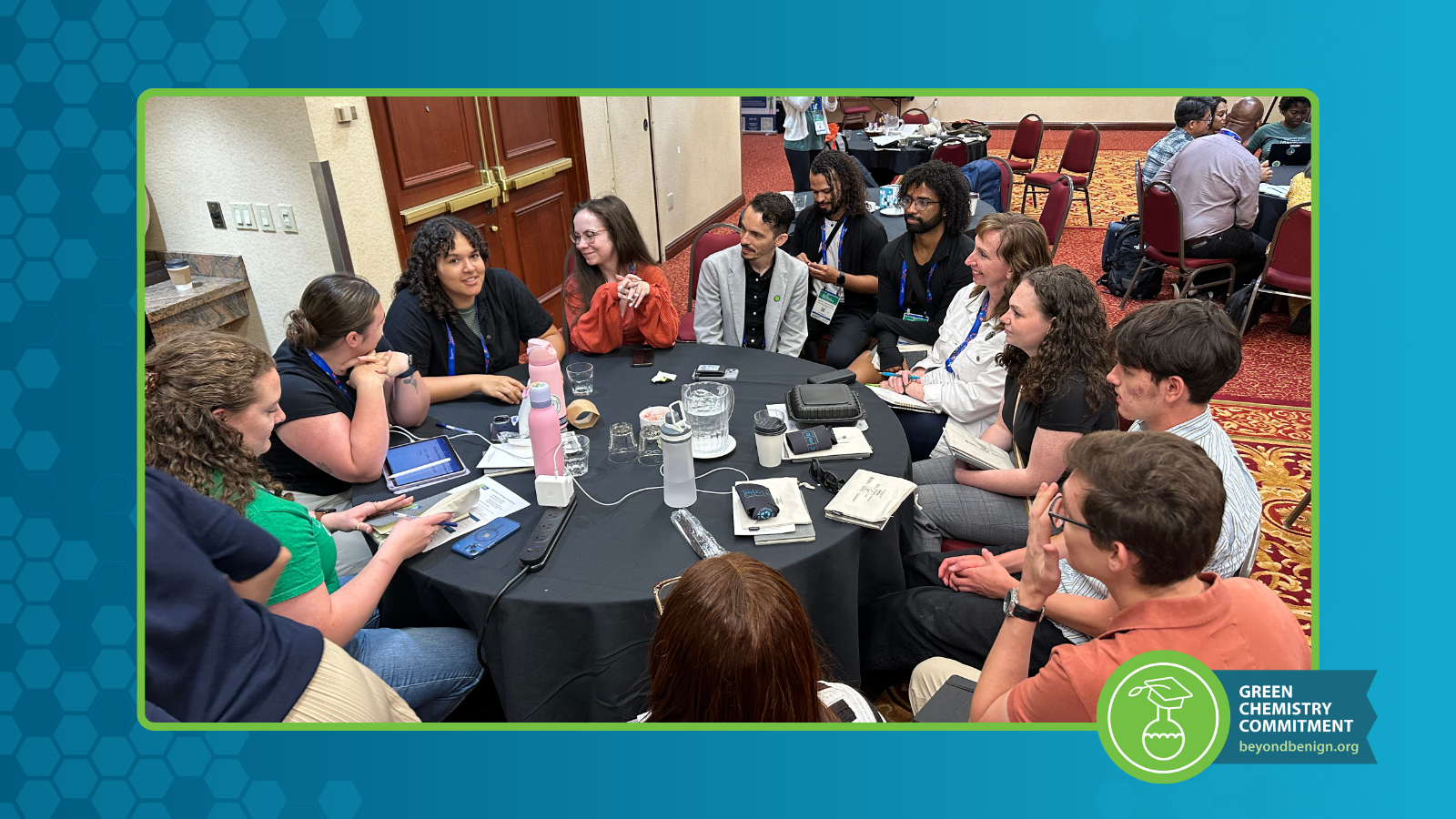 Photo of attendees sitting at a table during the 2025 GCC Summit.